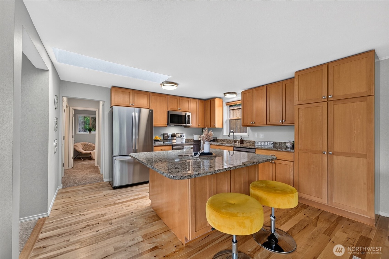 Open kitchen and living space with granite island